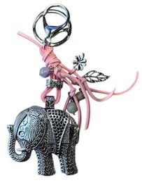 Elephant-shaped keychain with pink lace and floral accents.