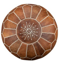 Cognac brown leather pouf with intricate star-shaped design, suitable for use as an ottoman or footstool.