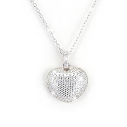 Silver heart-shaped charm necklace with intricate patterned design.