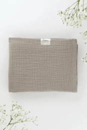 Soft, breathable muslin baby blanket in a neutral sand color. Made of high-quality cotton for comfort and durability.