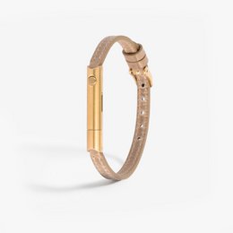 A classic sand-colored bangle bracelet with a gold-tone metal accent, designed for self-defense purposes.