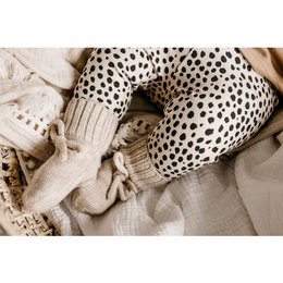 Cozy merino wool bootie slippers in a neutral sand color, perfect for keeping baby's feet warm and comfortable.