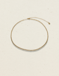 Delicate gold-toned charm necklace with a simple, elegant design.