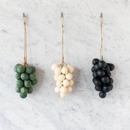 Handcrafted olive oil soap with grape-shaped design in cream, olive, and slate colors.