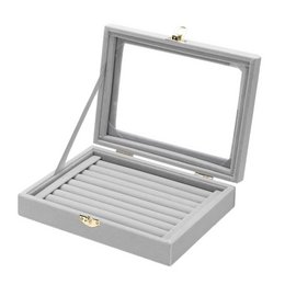 Grey jewelry box with slots for rings and cufflinks. Includes a clear lid for display.
