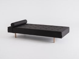 A modern, minimalist daybed with a wooden frame and black upholstery. The daybed features a tufted design and can accommodate multiple people.