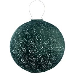 A round, green solar garden light with a floral pattern. The light is made of metal and has a hanging design.