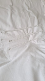 A white headband holder with a floral pattern and a curved shape, suitable for storing and organizing children's headbands.