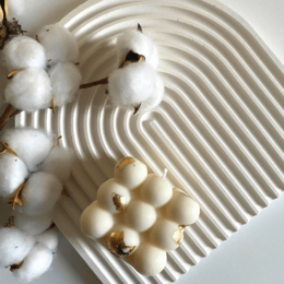  White decorative tray with a curved, arched design. Made of ceramic material. Includes a glass cup or mug placed on the tray.