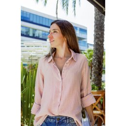 Oversized, off-white muslin blouse with a relaxed, flowing silhouette. Features a classic button-down design and long sleeves.