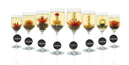 A set of tea accessories including a pink rose, a white box, and a white card with gold accents. The set appears to be a tea starter kit or gift set.