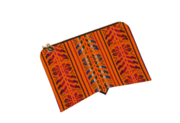 Vibrant orange handbag with intricate ethnic-inspired patterns and textures.