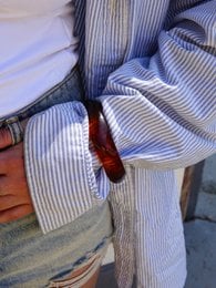 Bold tortoise bangle, a stylish accessory with a unique tortoise shell pattern and a sleek, curved design.