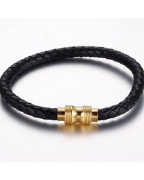 A braided leather bracelet with a gold-tone clasp. The bracelet features a simple, classic design in a black color.