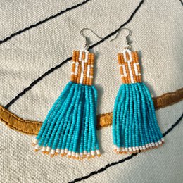  Handmade statement earrings with long red and turquoise beaded fringe, featuring a unique and bohemian style.