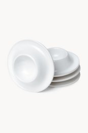 Set of 4 ceramic egg cups in white and black colors. Smooth, round shape with a simple, minimalist design.