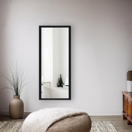 A rectangular black framed wall mirror in various sizes, suitable for use in a living room or bedroom.