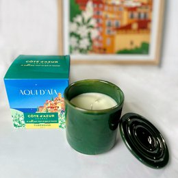  Green cylindrical scented candle with black lid, cream-colored wax, luxury French Tuberose fragrance, elegant minimalist design.