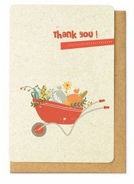 A colorful thank you card featuring a wheelbarrow filled with various gardening tools and flowers. The card has a simple "thank you!" message in red text.