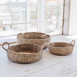 A set of 3 woven storage baskets in a natural, earthy color. The baskets have handles and are suitable for storing various household items.

The image shows a set of 3 woven storage baskets in a natural, earthy color. The baskets have handles and are suitable for storing various household items. The baskets appear to be made of a natural material, likely wicker or seagrass, and have a rustic, handcrafted look. This product would be suitable for use in a variety of home decor styles, from farmhouse to boho chic.