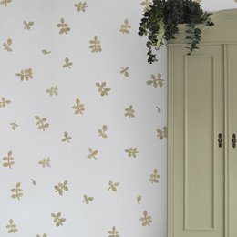 Watercolor leaves wall stickers in various colors including yellow, green, grey, brown, and pink. The stickers feature a repeating pattern of leaf shapes.