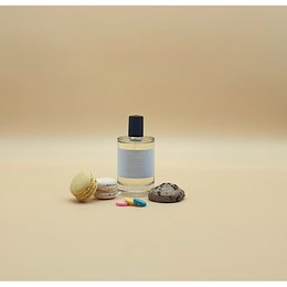 Elegant white perfume bottle with floral and natural elements, suggesting a high-quality, natural fragrance.
