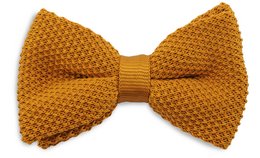 A knitted kids bow tie in a cognac color. The bow tie has a textured, woven pattern and a solid-colored center band.