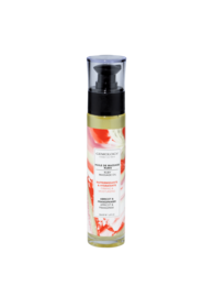  Ruby massage oil in a clear bottle with a red and white label. The oil has a floral and citrus scent, and is designed to firm and moisturize the skin.