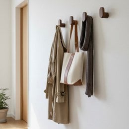 Wooden clothing hangers in walnut and oak finishes, with a simple, minimalist design.