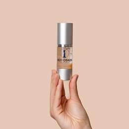 Antiaging serum in a silver bottle with a pump dispenser. Formulated to reduce the appearance of fine lines and wrinkles.