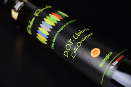 Organic EVO Oil DOP Umbria, a high-quality extra virgin olive oil from the Umbria region of Italy. The bottle features a vibrant, colorful design.