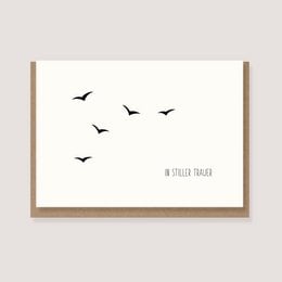 Folding card with envelope featuring a minimalist design of silhouetted birds in flight against a plain background, with the text "In silent mourning" below.