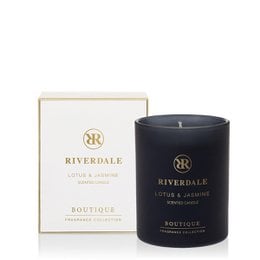  A white and black candle in a glass container, with the Riverdale logo and text "Lotus & Jasmine" on the label. The candle is described as a boutique scented candle with a height of 10cm.