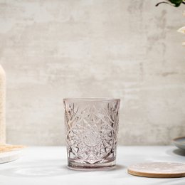 A set of 6 crystal-cut glasses in a variety of pastel colors, including lavender, yellow, and blue-green. The glasses feature a classic hobstar pattern with intricate diamond-shaped facets that catch and refract light, creating a beautiful and elegant effect.