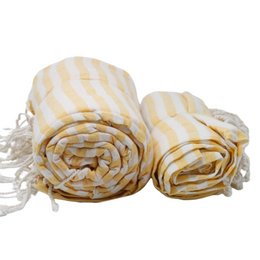 A large, striped yellow and white cotton beach towel with tasseled edges. The towel appears to be soft, absorbent, and suitable for use at the beach or pool.