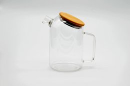 A clear glass carafe with a wooden lid, designed for serving tea. The carafe has a simple, elegant shape and a functional design.