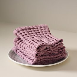 Mellow mauve cotton waffle weave face towel, soft textured bathroom hand towel in purple pink.
