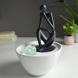 Modern indoor fountain with colored LED light, featuring a Pensador-style abstract figure in a Zen-inspired design. Quick and easy installation.