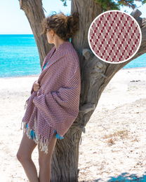 Red and white patterned Turkish hammam towel with fringed edges, suitable for use in spas, saunas, and at the beach.