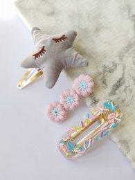 Set of 3 blue star-shaped hair clips with floral accents, suitable for kids' hairstyles.