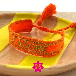  Woven bracelet in vibrant orange color with gold-tone "J'adore" text and tassel accent. Made of durable materials for a stylish accessory.