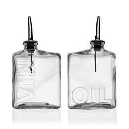 A set of two clear glass oil and vinegar bottles with black caps. The bottles have the words "OIL" and "VINEGAR" etched into the glass, indicating their contents.