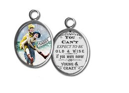 Colorful pendant with a retro-style illustration of a woman and the text "You can't keep a good girl down". The pendant has a round shape and a metal frame.