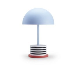 Portable lamp with a round, dome-shaped light shade in a blue color. The lamp has a striped base in black and white. This table lamp would provide soft, ambient lighting in a modern or minimalist interior.