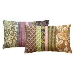 Decorative cushion with boho-inspired patchwork design featuring various patterns and colors including green, brown, and gold. Rectangular shape suitable for living room or bedroom decor.