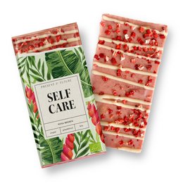 Pink raspberry chocolate bar with tropical leaf design packaging.