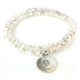"Crystal bracelet with Om - opal, double. Charm bracelet with beads in shades of white, cream, and gold. Features a pendant with an Om symbol."

The image shows a crystal bracelet with a double-strand design. The beads are in shades of white, cream, and gold, creating a soft, natural color palette. The bracelet features a pendant charm with an Om symbol, which is a sacred symbol in Hinduism and Buddhism. This bracelet would be suitable for those interested in spiritual or yoga-inspired jewelry.