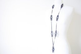 Long blue necklace with oval-shaped charms