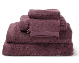 Plush burgundy-colored bath towels made of soft, absorbent material. Includes a hand towel, face towel, and bath towel in a coordinated set.