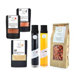 This gift set includes a variety of spice mixes and seasonings for grilling, including a rub, marinade, and spice blend. The set comes in a wooden crate with the "Mann am Grill" (Man at the Grill) branding.